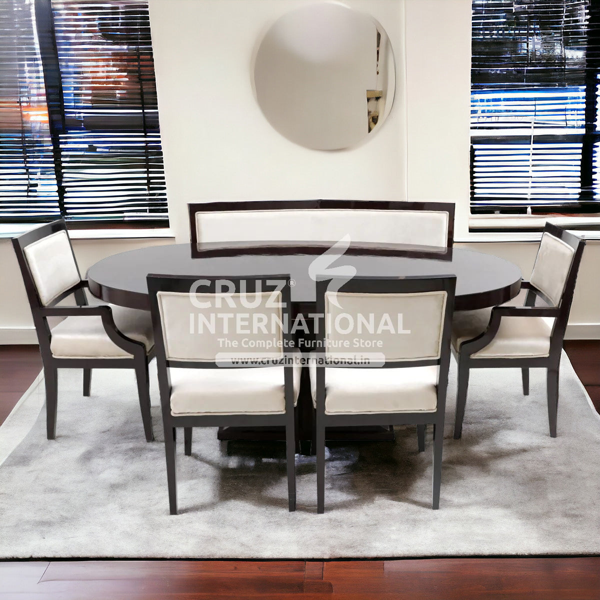 A set of round wooden dining tables with matching chairs upholstered in beige fabric, set in a room with a white carpet and a mirrored wall.